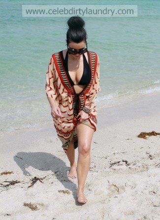 Love the wrap bathing suit cover up Kim has on I can't see very well but it