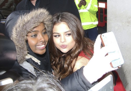 51993564 Singer and actress Selena Gomez poses for pictures with fan as she visits the BBC Radio 1 in London, England on March 11, 2016. In the three days Selena attended fashion week, she wore nine different outfits! FameFlynet, Inc - Beverly Hills, CA, USA - +1 (310) 505-9876 RESTRICTIONS APPLY: USA/CHINA ONLY
